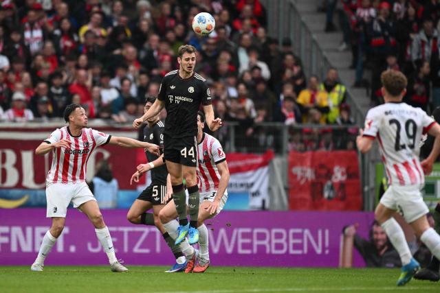 Bayern Munich's Croatian defender #44 Josip Stanisic gets up to head the ball during the German first division Bundesliga football match between SC Freiburg and FC Bayern Munich in Freiburg, southern Germany on April 4, 2026. (Photo by Silas STEIN / AFP) / DFL REGULATIONS PROHIBIT ANY USE OF PHOTOGRAPHS AS IMAGE SEQUENCES AND/OR QUASI-VIDEO