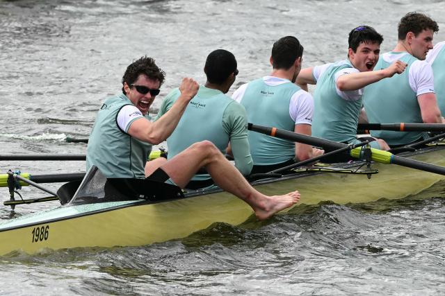 Cambridge crew, (R-L) Gabriel Obholzer, Patrick Wild, Kyle Fram, French president, Noam Mouelle, and Simon Hatcher celebrate at the finish of the 171th men's boat race between Oxford University and Cambridge University on the River Thames in London on April 4, 2026. (Photo by JUSTIN TALLIS / AFP)
