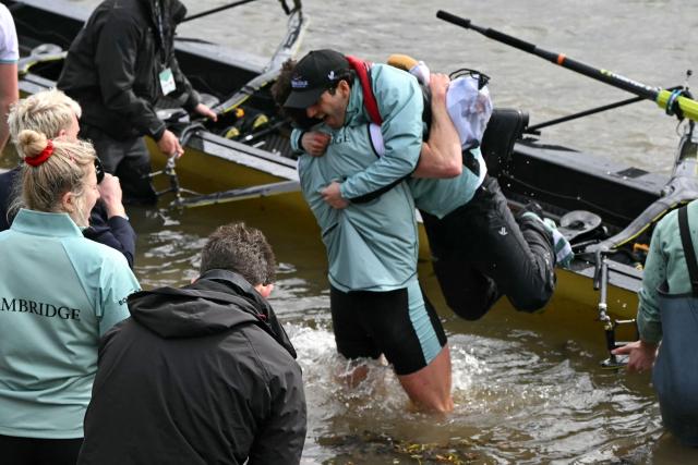 Cambridge Cox, Sammy Houdagui, is embraced at the finish of the 171th men's boat race between Oxford University and Cambridge University on the River Thames in London on April 4, 2026. (Photo by JUSTIN TALLIS / AFP)