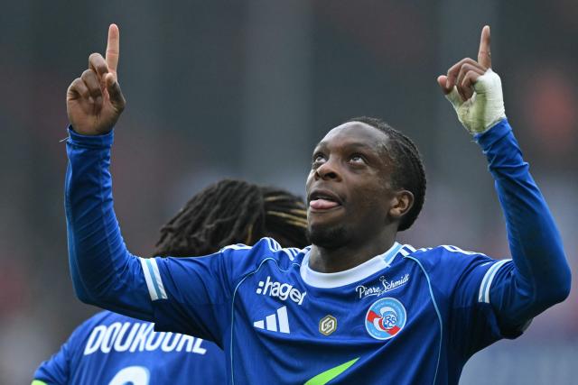 Strasbourg's Ivorian forward #20 Martial Godo celebrates his team's first goal during the French L1 football match between RC Strasbourg Alsace and OGC Nice at the Stade de la Meinau in Strasbourg, eastern France, on April 4, 2026. (Photo by SEBASTIEN BOZON / AFP)