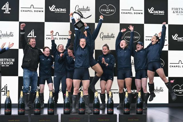 The Oxford crew celebrate with the trophy on the podium after the 80th Women's boat race between Oxford University and Cambridge University on the River Thames in London on April 4, 2026. (Photo by JUSTIN TALLIS / AFP)
