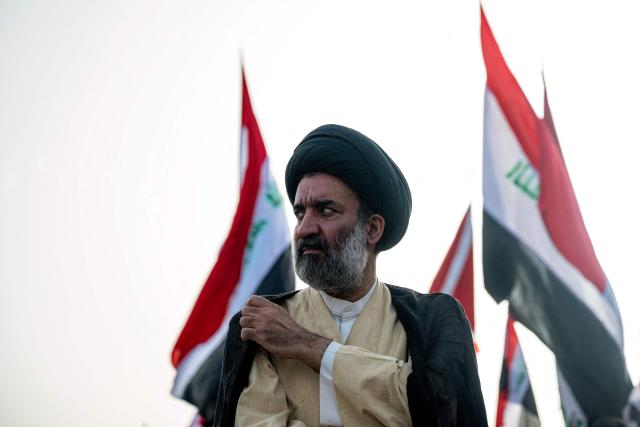 A Shia Muslim cleric looks on during a demonstration in solidarity with Iran and denouncing the US-Israeli war against it, in Iraq's southern city of Basra on April 4, 2026. Iraq, long a proxy battleground between the United States and Iran, was quickly dragged into the Middle East war triggered by US and Israeli strikes on Iran on February 28. (Photo by Hussein FALEH / AFP)