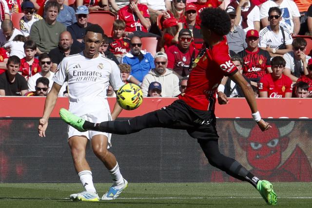Real Madrid's English defender #12 Trent Alexander-Arnold (L) fights for the ball with Real Mallorca’s Colombian defender #22 Johan Mojica during the Spanish league football match between RCD Mallorca and Real Madrid CF at Mallorca Son Moix Stadium in Palma de Mallorca on April 4, 2026. (Photo by JAIME REINA / AFP)