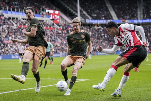 Utrecht's Belgian defender #02 Siebe Horemans (L) fights for the ball with Utrecht's Danish defender #23 Niklas Vesterlund (C) and PSV Eindhoven's Brazilian defender #17 Mauro Junior during the Dutch Eredivisie football match between PSV Eindhoven and FC Utrecht at Philips Stadion in Eindhoven on April 4, 2026. (Photo by Tobias Kleuver / ANP / AFP) / Netherlands OUT