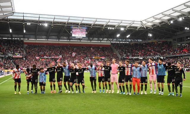 Players of FC Bayern Munich celebrate after the German first division Bundesliga football match between SC Freiburg and FC Bayern Munich in Freiburg, southern Germany on April 4, 2026. (Photo by Silas STEIN / AFP) / DFL REGULATIONS PROHIBIT ANY USE OF PHOTOGRAPHS AS IMAGE SEQUENCES AND/OR QUASI-VIDEO