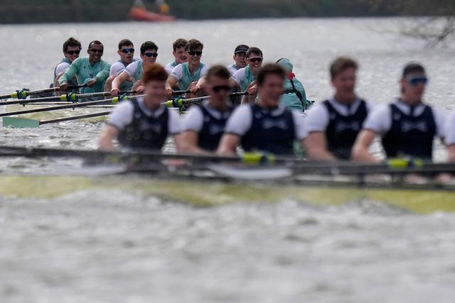 (R-L) Cambridge's Cox, Sammy Houdagui and rowers Freddy Breuer, Will Klipstine, Lexi McClean, Gabriel Obholzer, Patrick Wild, Kyle Fram, French president, Noam Mouelle, and Simon Hatcher compete in the 171th men's boat race between Oxford University and Cambridge University on the River Thames in London on April 4, 2026. (Photo by CARLOS JASSO / AFP)