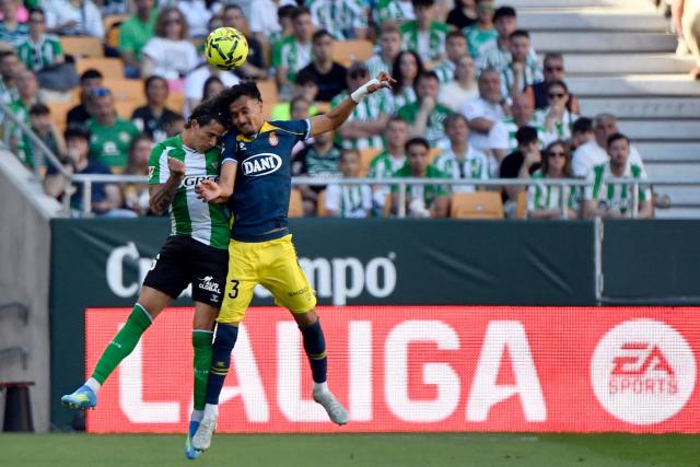 Real Betis' Argentinian defender #16 Valentin Gomez (L) and Espanyol's Moroccan defender #23 Omar El Hilali vie for a header during the Spanish league football match between Real Betis and RCD Espanyol at Benito Villamarin Stadium in Seville on April 4, 2026. (Photo by CRISTINA QUICLER / AFP)