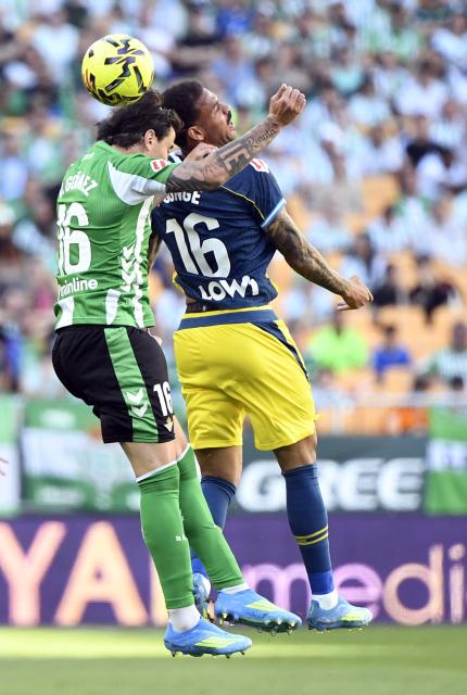 Real Betis' Argentinian defender #16 Valentin Gomez (L) and Espanyol's Belgian midfielder #16 Cyril Ngonge vie for a header during the Spanish league football match between Real Betis and RCD Espanyol at Benito Villamarin Stadium in Seville on April 4, 2026. (Photo by CRISTINA QUICLER / AFP)