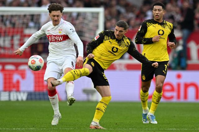 Dortmund's Austrian midfielder #20 Marcel Sabitzer (C) Stuttgart's Portuguese forward #08 Tiago Tomas (L) vie for the ball during the German first division Bundesliga football match between VfB Stuttgart and BVB Borussia Dortmund in Stuttgart, southern Germany, on April 4, 2026. (Photo by THOMAS KIENZLE / AFP) / DFL REGULATIONS PROHIBIT ANY USE OF PHOTOGRAPHS AS IMAGE SEQUENCES AND/OR QUASI-VIDEO