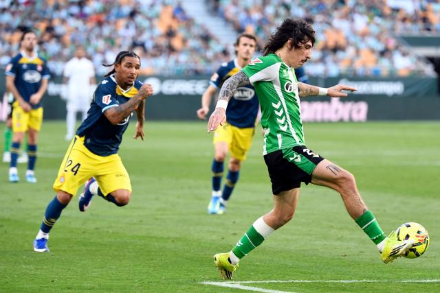 Real Betis' Spanish defender #02 Hector Bellerin kicks the ball  challenged by Espanyol's English forward #24 Tyrhys Dolan during the Spanish league football match between Real Betis and RCD Espanyol at Benito Villamarin Stadium in Seville on April 4, 2026. (Photo by CRISTINA QUICLER / AFP)