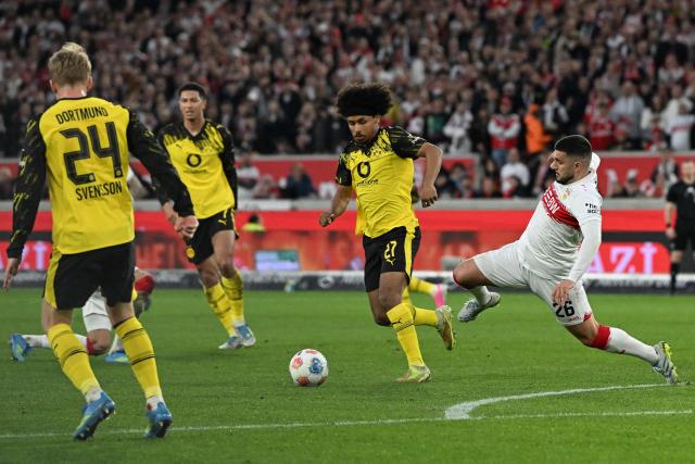Stuttgart's German forward #26 Deniz Undav (R) and Dortmund's German forward #27 Karim Adeyemi vie for the ball during the German first division Bundesliga football match between VfB Stuttgart and BVB Borussia Dortmund in Stuttgart, southern Germany, on April 4, 2026. (Photo by THOMAS KIENZLE / AFP) / DFL REGULATIONS PROHIBIT ANY USE OF PHOTOGRAPHS AS IMAGE SEQUENCES AND/OR QUASI-VIDEO