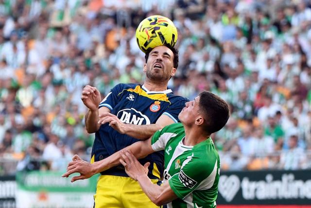 Espanyol's Spanish midfielder #08 Edu Exposito wins a header against Real Betis' Spanish midfielder #06 Sergi Altimira (R) during the Spanish league football match between Real Betis and RCD Espanyol at Benito Villamarin Stadium in Seville on April 4, 2026. (Photo by CRISTINA QUICLER / AFP)