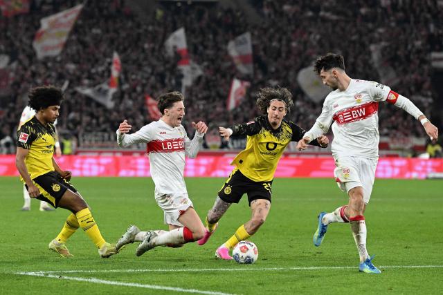Stuttgart's German midfielder #06 Angelo Stiller (2nd L) is fouled by Dortmund's German forward #27 Karim Adeyemi (L) during the German first division Bundesliga football match between VfB Stuttgart and BVB Borussia Dortmund in Stuttgart, southern Germany, on April 4, 2026. (Photo by THOMAS KIENZLE / AFP) / DFL REGULATIONS PROHIBIT ANY USE OF PHOTOGRAPHS AS IMAGE SEQUENCES AND/OR QUASI-VIDEO