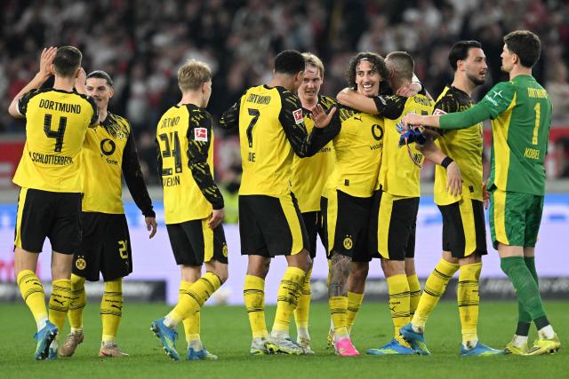 Dortmund players celebrate after the German first division Bundesliga football match between VfB Stuttgart and BVB Borussia Dortmund in Stuttgart, southern Germany, on April 4, 2026. (Photo by THOMAS KIENZLE / AFP) / DFL REGULATIONS PROHIBIT ANY USE OF PHOTOGRAPHS AS IMAGE SEQUENCES AND/OR QUASI-VIDEO