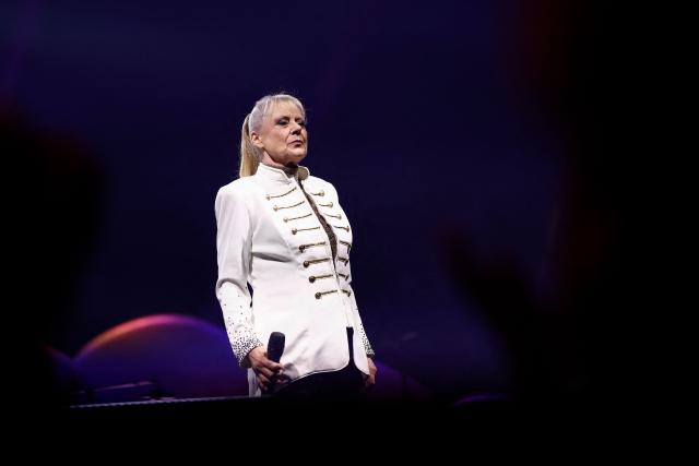 Former French TV host and singer Frederique Hoschede, also known as Dorothee, performs on stage at the Palais des Congres concert hall in Paris on April 4, 2026. (Photo by Kenzo TRIBOUILLARD / AFP)
