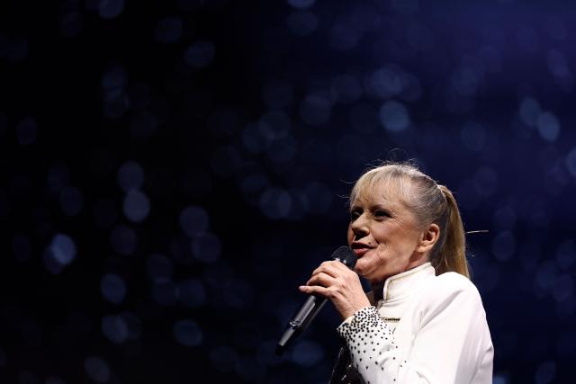 Former French TV host and singer Frederique Hoschede, also known as Dorothee, performs on stage at the Palais des Congres concert hall in Paris on April 4, 2026. (Photo by Kenzo TRIBOUILLARD / AFP)