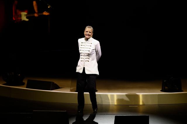 Former French TV host and singer Frederique Hoschede, also known as Dorothee, acknowledges the audience as she performs on stage at the Palais des Congres concert hall in Paris on April 4, 2026. (Photo by Kenzo TRIBOUILLARD / AFP)