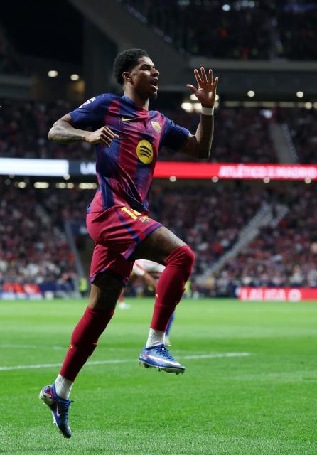 Barcelona's English forward #14 Marcus Rashford celebrates scoring his team's first goal during the Spanish league football match between Club Atletico de Madrid and FC Barcelona at Metropolitano Stadium in Madrid on April 4, 2026. (Photo by Pierre-Philippe MARCOU / AFP)