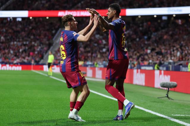 Barcelona's English forward #14 Marcus Rashford (R) celebrates scoring his team's first goal with Barcelona's Spanish midfielder #16 Fermin Lopez during the Spanish league football match between Club Atletico de Madrid and FC Barcelona at Metropolitano Stadium in Madrid on April 4, 2026. (Photo by Pierre-Philippe MARCOU / AFP)