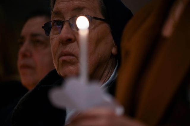Christian worshippers hold candles as they attend an Easter Vigil at the Cathedral of St. Mother Teresa in Pristina, Kosovo on April 4, 2026. (Photo by Armend NIMANI / AFP)