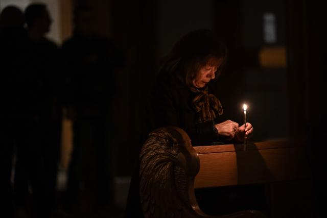 A Christian worshipper holds a candle as she attends an Easter Vigil at the Cathedral of St. Mother Teresa in Pristina, Kosovo on April 4, 2026. (Photo by Armend NIMANI / AFP)