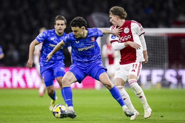 FC Twente's Israeli midfielder #23 Stav Lemkin (C) vies with Ajax's Belgian forward #11 Mika Godts (R) during the Dutch Eredivisie football match between AFC Ajax and FC Twente at the Johan Cruijff ArenA in Amsterdam on April 4, 2026. (Photo by Olaf Kraak / ANP / AFP) / Netherlands OUT