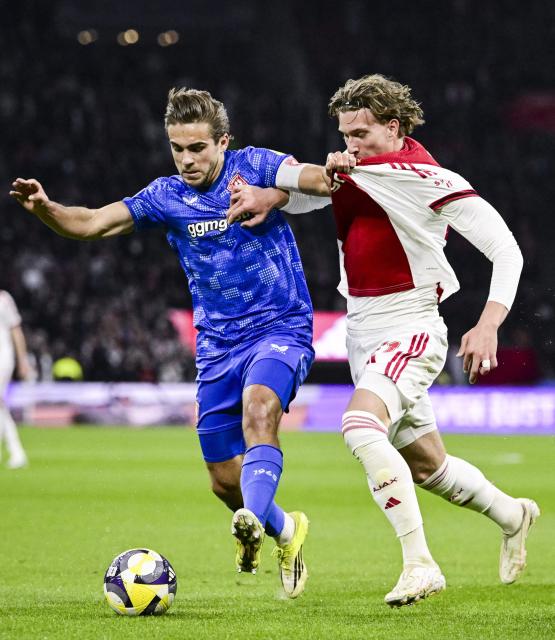 FC Twente's Dutch defender #28 Bart van Rooij (L) vies with Ajax's Belgian forward #11 Mika Godts (R) during the Dutch Eredivisie football match between AFC Ajax and FC Twente at the Johan Cruijff ArenA in Amsterdam on April 4, 2026. (Photo by Olaf Kraak / ANP / AFP) / Netherlands OUT