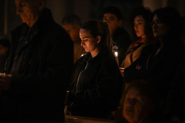 Christian worshippers hold candles as they attend an Easter Vigil at the Cathedral of St. Mother Teresa in Pristina, Kosovo on April 4, 2026, as part of the Holy Week celebrations. (Photo by Armend NIMANI / AFP)