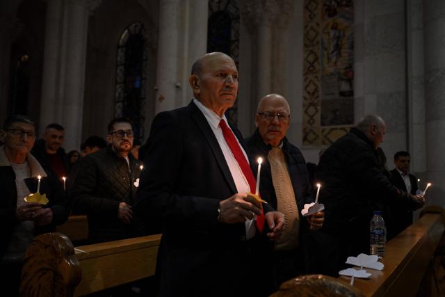 Christian worshippers hold candles as they attend an Easter Vigil at the Cathedral of St. Mother Teresa in Pristina, Kosovo on April 4, 2026, as part of the Holy Week celebrations. (Photo by Armend NIMANI / AFP)