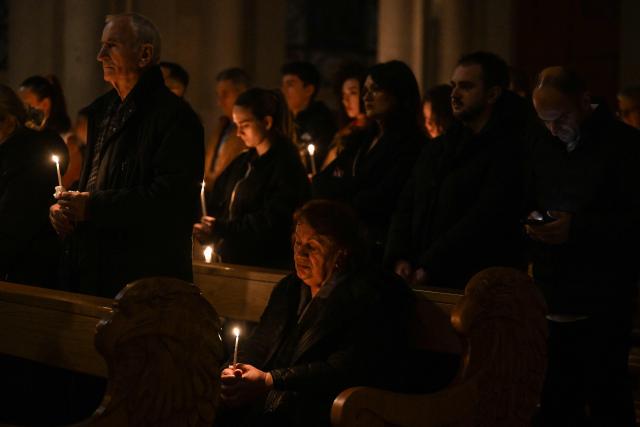 Christian worshippers hold candles as they attend an Easter Vigil at the Cathedral of St. Mother Teresa in Pristina, Kosovo on April 4, 2026, as part of the Holy Week celebrations. (Photo by Armend NIMANI / AFP)
