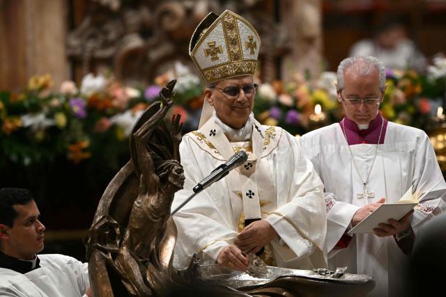 Pope Leo XIV prepares to baptize a person during the Easter vigil as part of the Holy Week celebrations, at St Peter's basilica in the Vatican on April 4, 2026. (Photo by Andreas SOLARO / AFP)