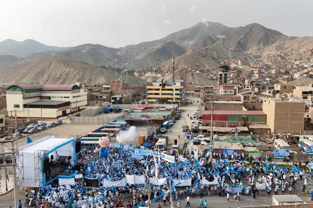 This aerial view shows supporters of Peru's presidential candidate Rafael Lopez Aliaga, of the Renovacion Popular party, gathering for a campaign rally in Lima on April 4, 2026. Peru will hold presidential elections on April 12. (Photo by Connie FRANCE / AFP)