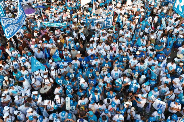 This aerial view shows supporters of Peru's presidential candidate Rafael Lopez Aliaga, of the Renovacion Popular party, gathering for a campaign rally in Lima on April 4, 2026. Peru will hold presidential elections on April 12. (Photo by Connie FRANCE / AFP)