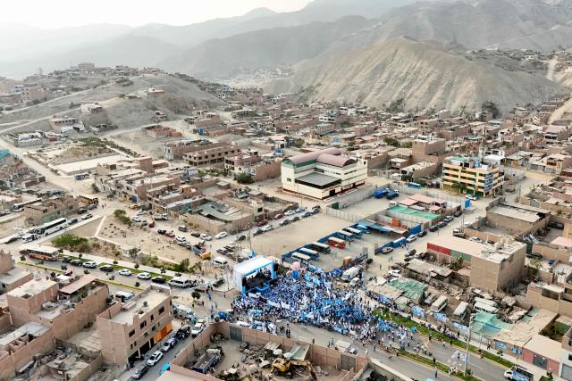 This aerial view shows supporters of Peru's presidential candidate Rafael Lopez Aliaga, of the Renovacion Popular party, gathering for a campaign rally in Lima on April 4, 2026. Peru will hold presidential elections on April 12. (Photo by Connie FRANCE / AFP)