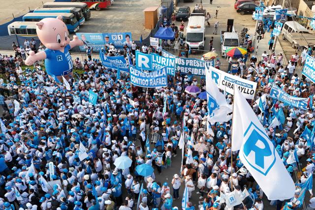 This aerial view shows supporters of Peru's presidential candidate Rafael Lopez Aliaga, of the Renovacion Popular party, gathering for a campaign rally in Lima on April 4, 2026. Peru will hold presidential elections on April 12. (Photo by Connie FRANCE / AFP)