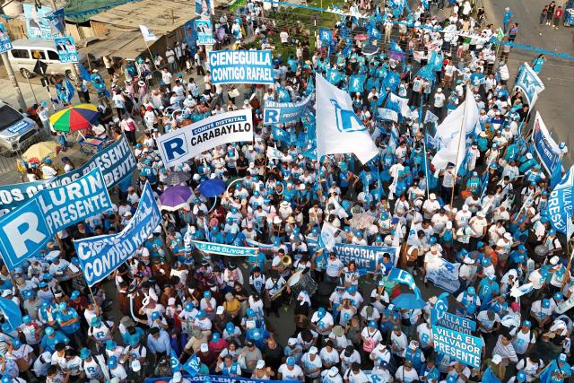 This aerial view shows supporters of Peru's presidential candidate Rafael Lopez Aliaga, of the Renovacion Popular party, gathering for a campaign rally in Lima on April 4, 2026. Peru will hold presidential elections on April 12. (Photo by Connie FRANCE / AFP)
