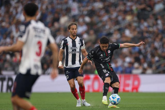San Luis' midfielder #21 Oscar Macias (R) kicks the ball past Monterrey's Spanish midfielder #10 Sergio Canales (L) during the Liga MX Clausura football match between Monterrey and San Luis at BBVA stadium in Guadalupe, Nuevo Leon state, Mexico, on April 4, 2026. (Photo by Julio Cesar AGUILAR / AFP)