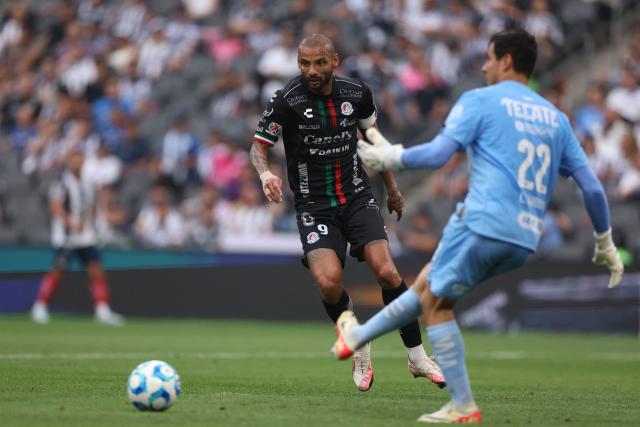San Luis' Brazilian forward #09 Joao Pedro looks at Monterrey's goalkeeper #22 Luis Cardenas kicking the ball during the Liga MX Clausura football match between Monterrey and San Luis at BBVA stadium in Guadalupe, Nuevo Leon state, Mexico, on April 4, 2026. (Photo by Julio Cesar AGUILAR / AFP)