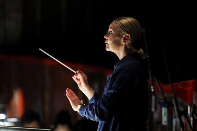 Finnish conductor Susanna Mälkki conducts a rehearsal of "Innocence", the final opera by the late Finnish composer Kaija Saariaho, at the Metropolitan Opera in New York on April 1, 2026. School shootings are a tragically common occurrence in the United States, but rarely do they grace the stage of one of the world's premier opera houses. But on Monday, Kaija Saariaho's "Innocence" -- which explores how a devastating attack at an international school in Finland reverberates through the lives of its survivors -- will debut at the Metropolitan Opera in New York. (Photo by ANGELA WEISS / AFP)
