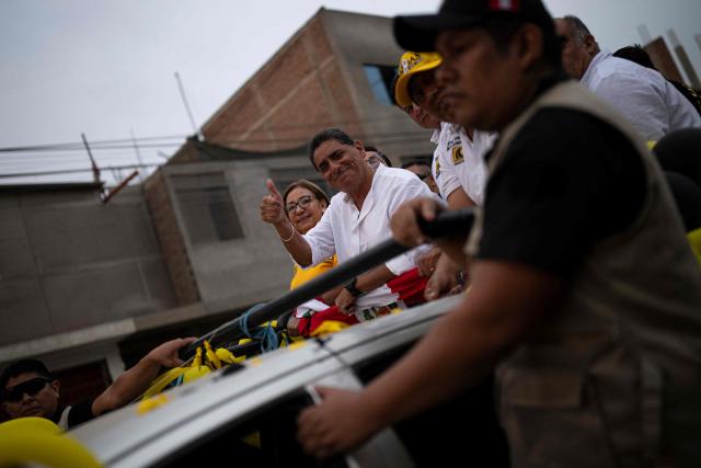 Peru's presidential candidate Carlos Alvarez for the Pais Para Todos party gives a thumbs up during a campaign rally in San Juan de Lurigancho district, on the outskirts of Lima, on April 4, 2026. Peru will hold presidential elections on April 12. (Photo by ERNESTO BENAVIDES / AFP)