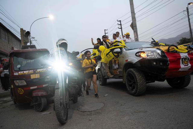 Peru's presidential candidate Carlos Alvarez (3rd-R) for the Pais Para Todos party stands on a truck bed during a campaign rally in San Juan de Lurigancho, on the outskirts of Lima, on April 4, 2026. Peru will hold presidential elections on April 12. (Photo by ERNESTO BENAVIDES / AFP)
