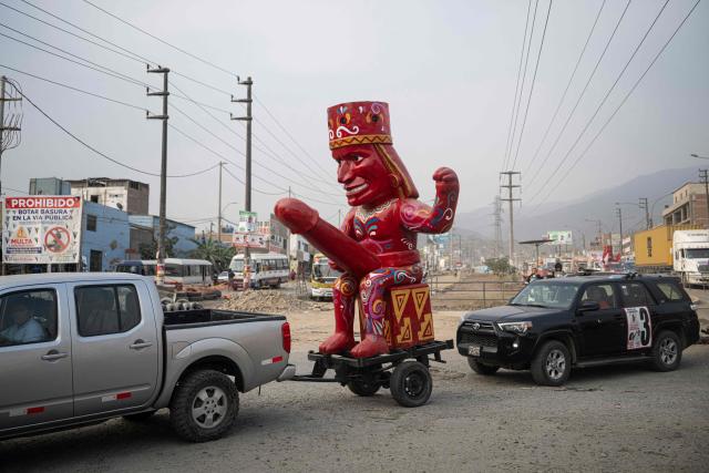 A figure depicting an erotic huaco from the Moche culture is pictured on a convoy in support to Peru's presidential candidate Rosario Fernandez for the Un Camino Diferente party in San Juan de Lurigancho district, on the outskirts of Lima, on April 4, 2026. Peru will hold presidential elections on April 12. (Photo by ERNESTO BENAVIDES / AFP)