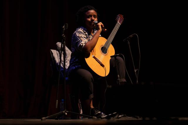 Brazilian guitarist Gabriele Leite speaks during the Queremos music festival at the Carlos Gomes theatre in Rio de Janeiro, Brazil on April 4, 2026. (Photo by Pablo PORCIUNCULA / AFP)