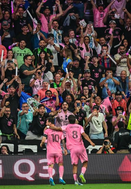 Inter Miami's Argentine forward #10 Lionel Messi and Inter Miami's Venezuelan midfielder #08 Telasco Segovia celebrate with fans after Messi scored his team first goal during a Major League Soccer (MLS) regular season football match between Inter Miami CF and Austin FC at the newly inaugurated NU Stadium in Miami, Florida, on April 4, 2026. (Photo by Giorgio VIERA / AFP)
