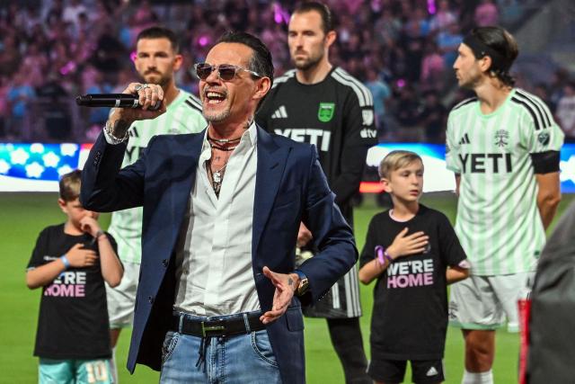 US singer Marc Anthony sings the national anthem before the start of a Major League Soccer (MLS) regular season football match between Inter Miami CF and Austin FC at the newly inaugurated NU Stadium in Miami, Florida, on April 4, 2026. (Photo by Giorgio VIERA / AFP)