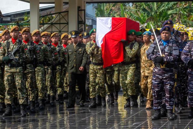 Military pallbearers carry the coffin of fallen compatriot and UN peacekeeper Farizal Rhomadhon during his funeral at the Giripeni Heroes' Cemetery in Kulon Progo, Yogyakarta, on April 5, 2026. Farizal was one of three Indonesian soldiers killed while serving with the United Nations Interim Force in Lebanon (UNIFIL) in southern Lebanon, where Israel and Hezbollah have been fighting since Lebanon was drawn into the Middle East war. (Photo by DEVI RAHMAN / AFP)