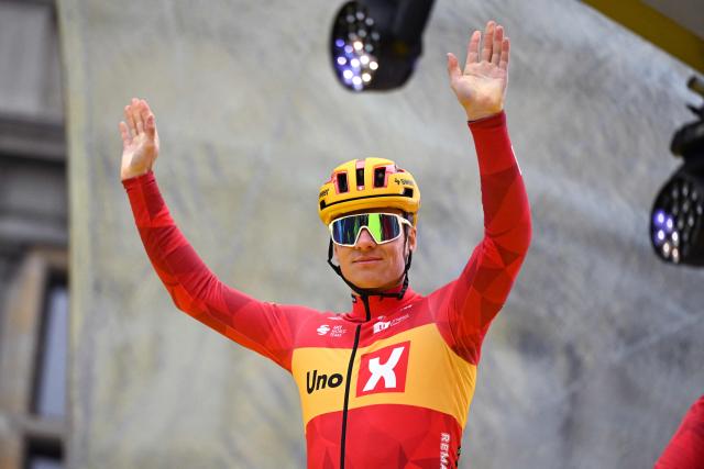 Norwegian Soren Waerenskjold of Uno-X Mobility greets supporters at the start of the men's race of the 'Ronde van Vlaanderen/ Tour des Flandres/ Tour of Flanders' UCI WorldTour one day cycling race, 278 km from Antwerp to Oudenaarde, on April 5, 2026. (Photo by ELIAS ROM / Belga / AFP) / Belgium OUT