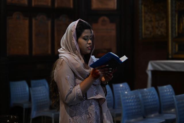 A woman prays on Easter Sunday commemorating the resurrection of Jesus at the Cathedral Church in Lahore on April 5, 2026. (Photo by Arif ALI / AFP)