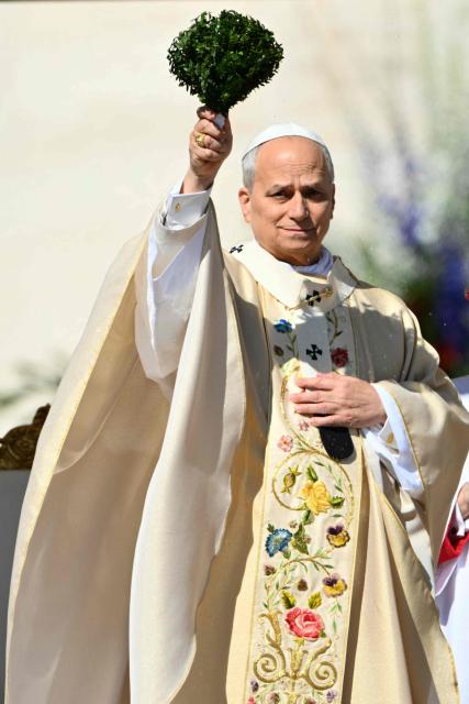 Pope Leo XIV blesses the crowd during the Easter Mass as part of the Holy Week celebrations, at St Peter's square in the Vatican on April 5, 2026. (Photo by Alberto PIZZOLI / AFP)