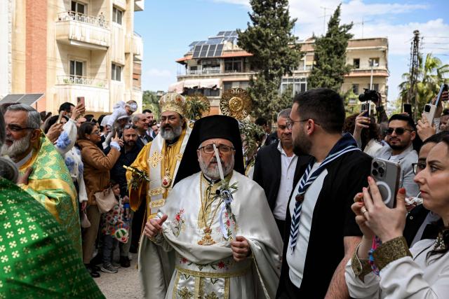 Clergymen march in a procession at the Greek Orthodox Church of the Holy Cross in the Qassaa district of Damascus on Orthodox Palm Sunday on April 5, 2026. (Photo by LOUAI BESHARA / AFP)